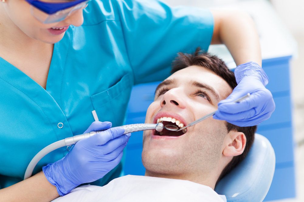 Wincing bearded man holding jaw in pain