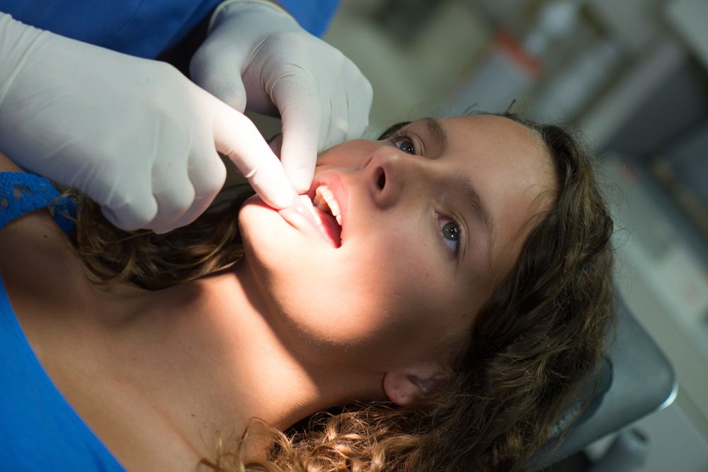 A woman undergoing an oral cancer screening.